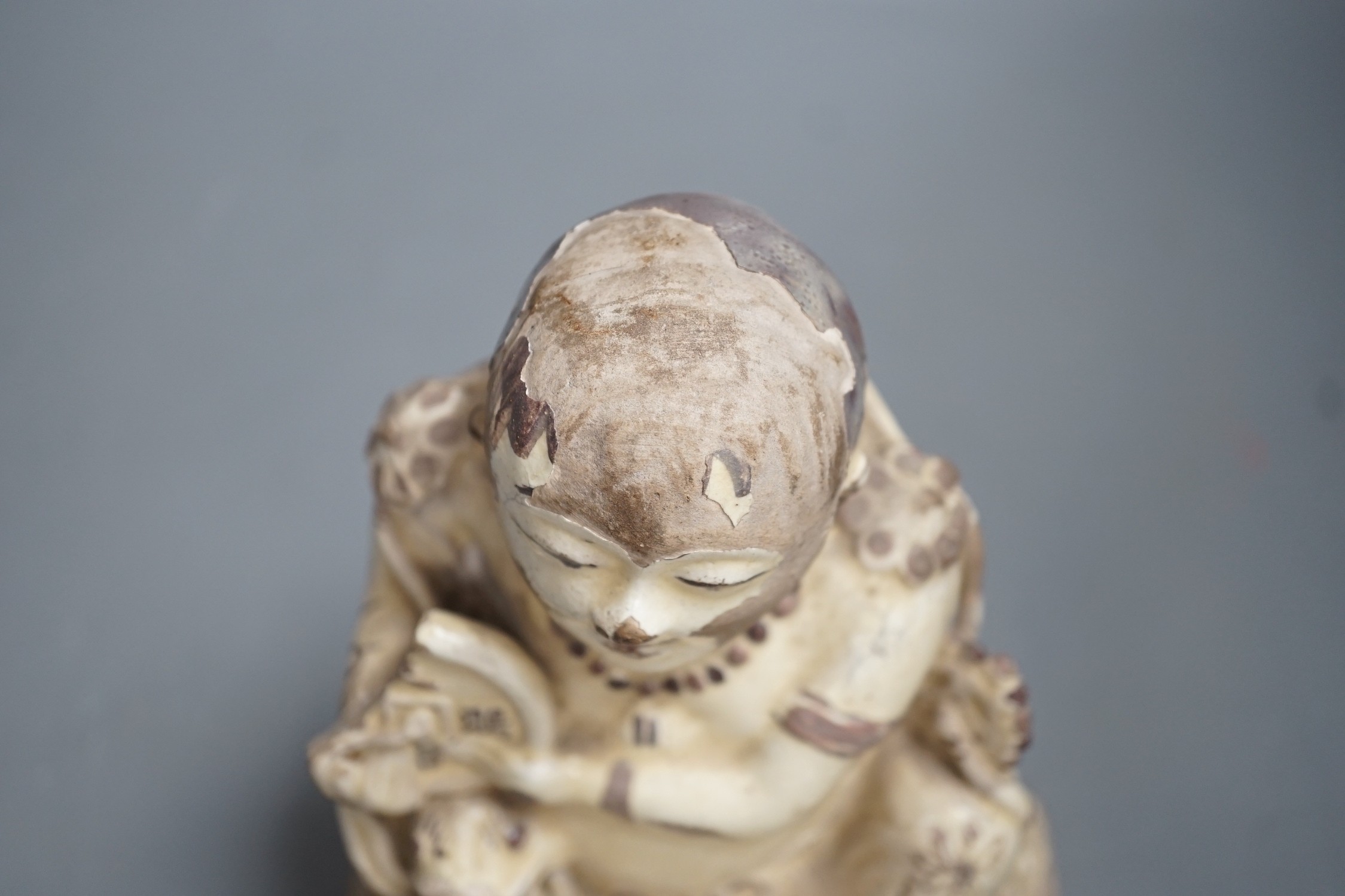 A Chinese Cizhou seated figure of Liu Hai, possibly Ming dynasty, 21cms high, glaze flaking